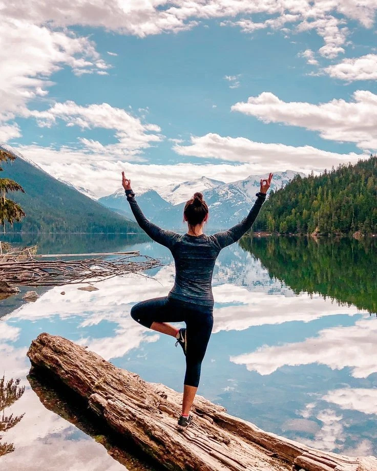 Yoga practitioner meditating, surrounded by nature's embrace